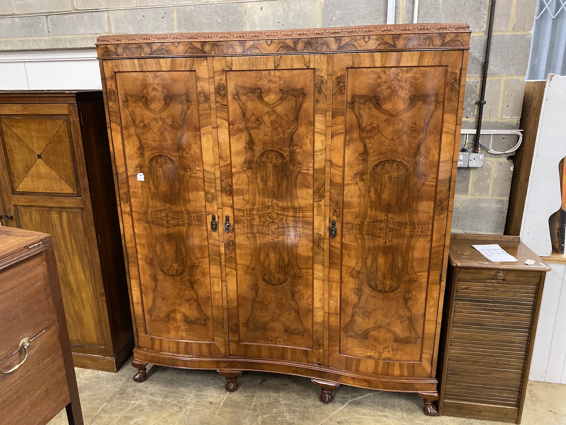 A Queen Anne revival figured walnut triple wardrobe, width 180cm, depth 56cm, height 205cm